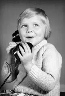 Pleased: Studio portrait, little boy on the phone