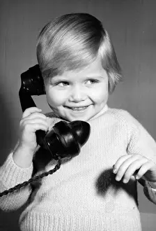 Pleased: Studio portrait, little boy on the phone