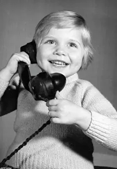 Pleased: Studio portrait, little boy on the phone