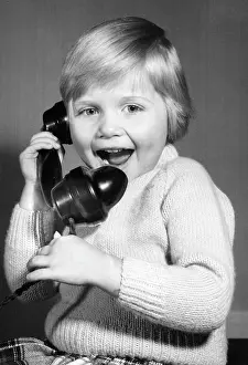 Excited: Studio portrait, little boy on the phone