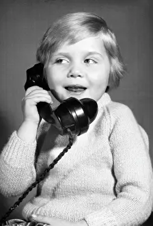 Pleased: Studio portrait, little boy on the phone
