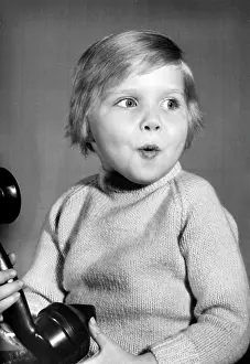 Excited: Studio portrait, little boy on the phone