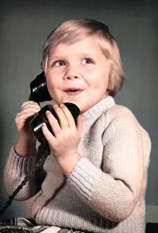 Excited: Studio portrait, little boy on the phone