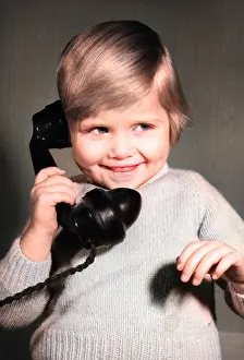 Pleased: Studio portrait, little boy on the phone