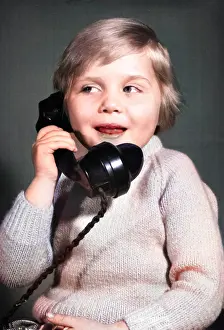 Pleased: Studio portrait, little boy on the phone