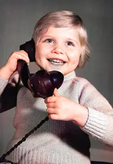 Pleased: Studio portrait, little boy on the phone