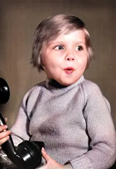 Excited: Studio portrait, little boy on the phone