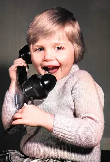 Excited: Studio portrait, little boy on the phone
