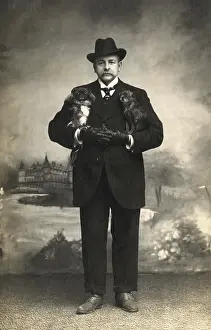 Pekes: Studio portrait, man with two Pekingese dogs
