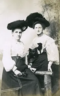 Belts: Studio portrait, two women with a small dog