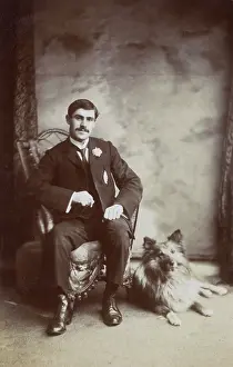 Buttonhole: Studio portrait, young man with his dog