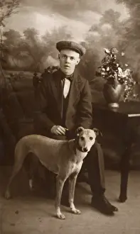 Lurcher: Studio portrait, young man with lurcher