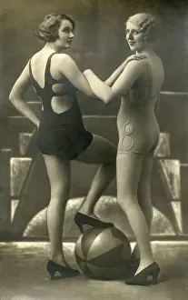 One Piece: Two stylish Swimwear models posing with a beach ball
