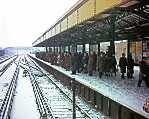 Commuters: Suburban railway station under snow