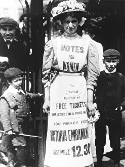 A suffragette advertising a votes for women march