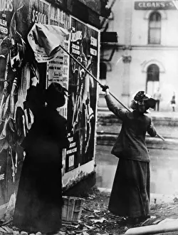Pasting: Two suffragettes posting a billboard in ?