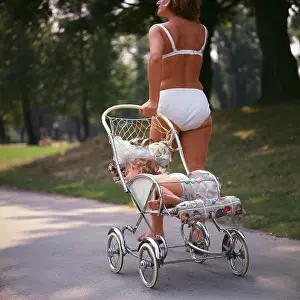 Bikinis: Summer in Vienna. Young woman in a bikini pulls