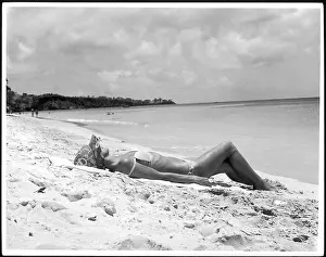 Bronzed: SUNBATHING ON SAND
