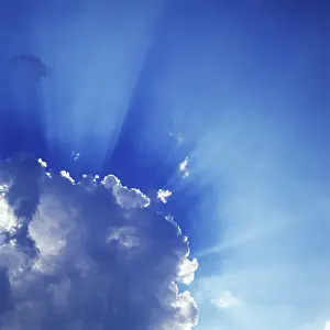 Brighter: Sun's Rays Around Cumulus Clouds