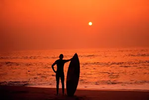 Surfer: Surfer standing admiring a Cornish Sunset