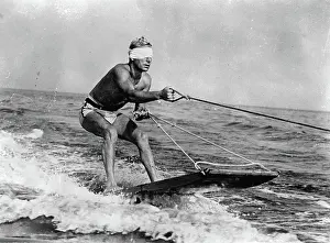 Surfer: A surfer - towed by a motorboat