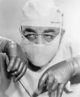 Exhausting: Surgeon in a surgical mask operating