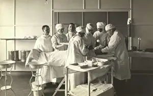 Surgery: Surgeons and nurses tending to a patient at