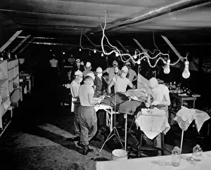Medical Care: Surgery is performed on a wounded soldier at the