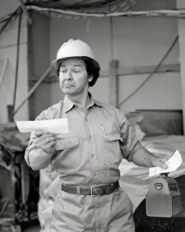Earnings: Surprised Workman wearing Work Clothes Hard Hat