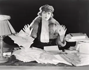 Businesswoman: Surrendering to an abundance of paperwork