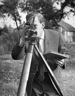 Theodolite: Surveyor at work with a theodolite