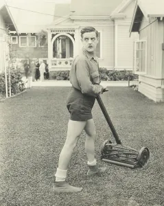 Trimmer: Suspicious man with a push reel lawn mower