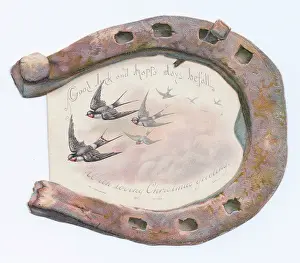 Horseshoes: Swallows and rusty horseshoe on a Christmas card