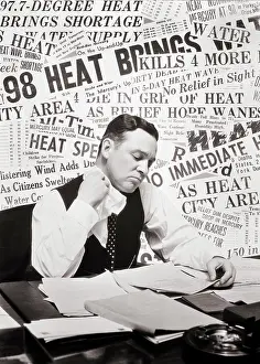 Perspiration: Sweating Man Sitting at Desk Reading Papers Using