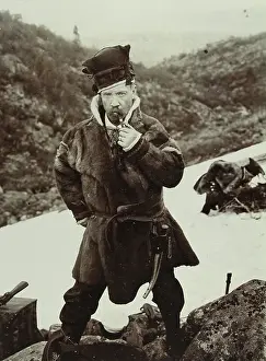 Sami: Sweden. Pipe smoking Sami with typical headgear. About?