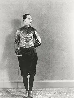 Fencer: Swordsman posing with fencing foil