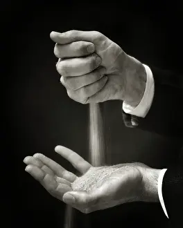 Idiom: Symbolic Hands of a Man Holding Letting Sands