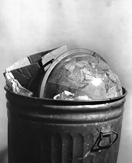 Camerique: Symbolic Image Of The Globe Thrown In A Trash Can
