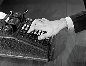 Fiscal: Symbolic male hand on manual adding machine