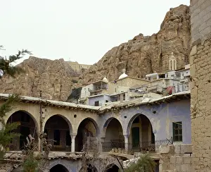Speakers: Syria. Maooloula. Town built into the rugged mountainside. V