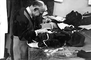 Balding: Tailor at work on a garment