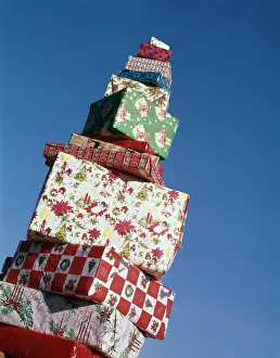 Diminishing: Tall pile of giftwrapped Christmas presents