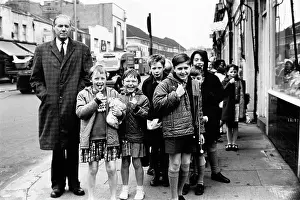 Anorak: Teacher and children with lollypops on an outing