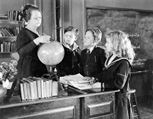 Mentor: Teacher in a classroom with three pupils pointing
