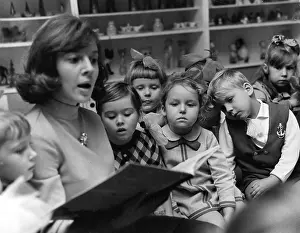 Huddle: Teacher reading to children