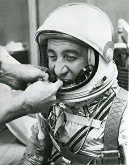 Microphones: A technician adjusts the microphones for astronaut Virg?