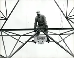 Enables: Ted Malpass on electricity pylon in protective suit