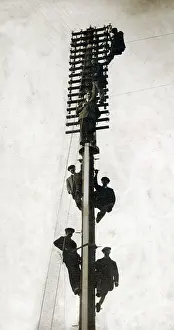 Installs: Telecommunication engineers installing a new telegraph pole