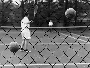 Alan Greeley Collection: TENNIS BALLS IN FENCE
