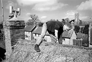 Thatch: Thatcher working on Somerset cottage -1